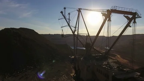Mining boom. Excavator loads ore.Panorama. Artificial lake. Sunset. Development 動画素材 73440692