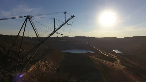 Mining boom. Excavator loads ore.Panorama. Artificial lake. Sunset. Development Stock-Footage 73441258