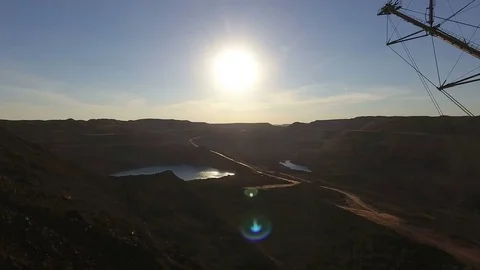 Mining boom. Excavator loads ore.Panorama. Artificial lake. Sunset. Development Stock Footage 73456193
