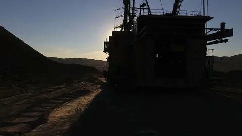 Mining boom. Excavator loads ore.Panorama. Artificial lake. Sunset. Development 動画素材 73457181
