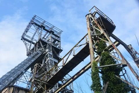Mining building and iron structure in front of blue sky Stock Photos