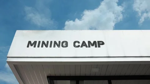 Mining camp word sign displayed on building with blue sky background Stock Footage 318759027