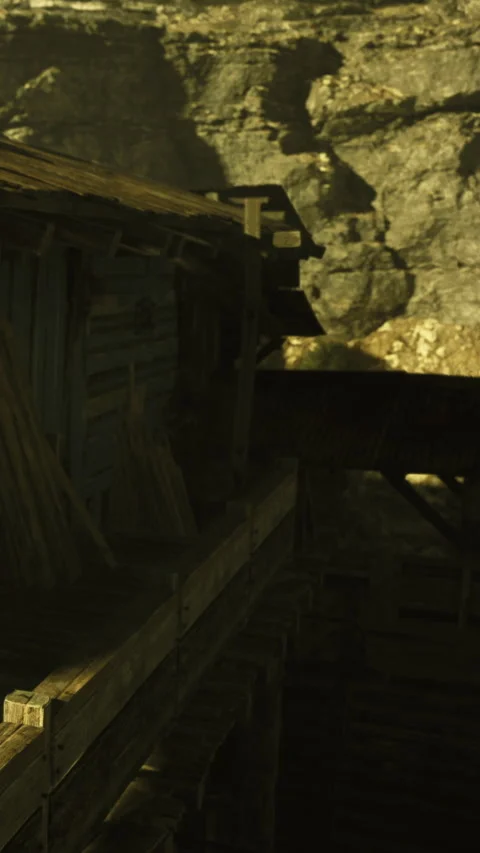Mining cart rests at an old structure in a dark cave during daylight Stock Footage 330273598