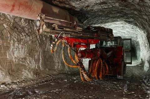 Mining drilling machine works in tunnel of salt quarry Stock Photos