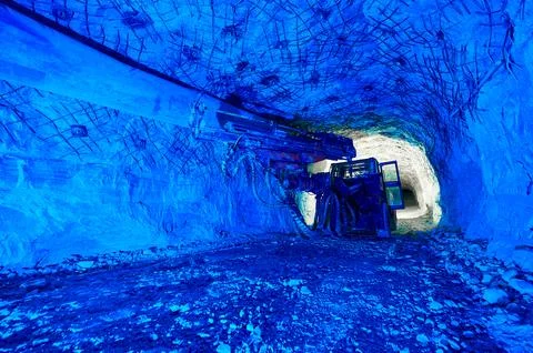 Mining drilling machine works in tunnel of salt quarry Stock Photos
