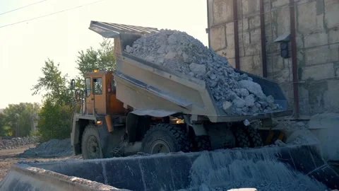 The mining dump truck dumps the stone into the bunker. Close-up Stock Footage 212365303