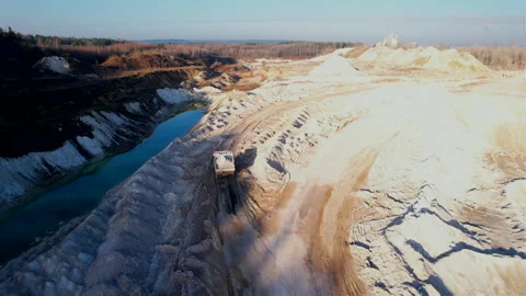 Mining dump truck transporting chalk rock from an open pit Stock Footage 186501036