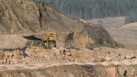 Mining dump trucks in the open pit mine. The dump truck goes on the Stock-Footage 94479171