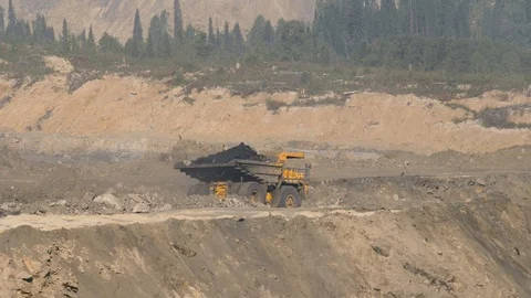 Mining dump trucks in the open pit mine. The dump truck goes on the Stock Footage 94479337
