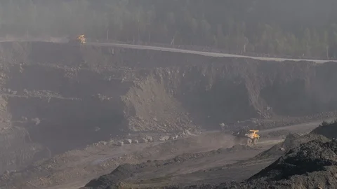 Mining dump trucks in the open pit mine. The dump truck goes on the Stock Footage 94479497