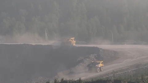 Mining dump trucks in the open pit mine. The dump truck goes on the Stock Footage 94479958