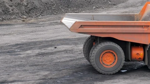 Mining dump trucks in the open pit mine. The dump truck goes on the Stock Footage 94480083
