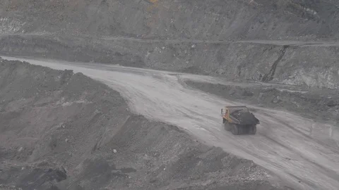 Mining dump trucks in the open pit mine. Loaded truck rides on the road quarry Stock Footage 94480686