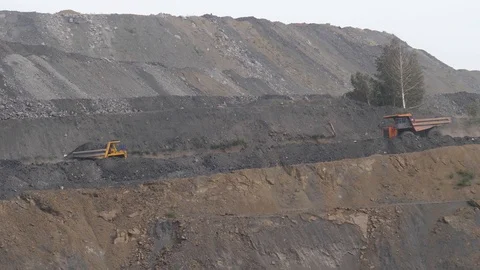 Mining dump trucks in the open pit mine. Loaded truck rides on the road quarry Video stock 94480850