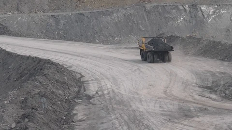 Mining dump trucks in the open pit mine. Loaded truck rides on the road quarry Stock Footage 94481069