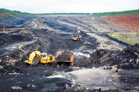 Mining dump trucks working in Lignite coalmine Stock Photos