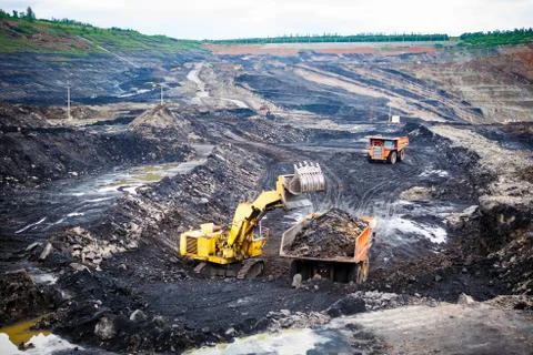 Mining dump trucks working in Lignite coalmine Stock Photos