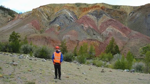 Mining engineer, a geologist in the protective reflective vest, gloves and Stock Footage 79462988