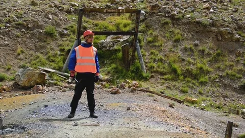 Mining engineer, a geologist in the protective reflective vest, gloves and Stock Footage 81481974