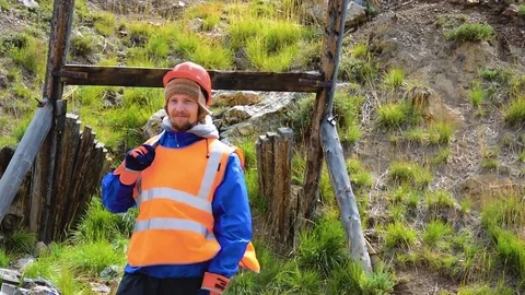 Mining engineer, a geologist in the protective reflective vest, gloves and Stock Footage 81484691