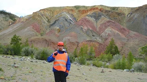 Mining engineer, a geologist in the protective reflective vest, gloves and Stock Footage 83491648