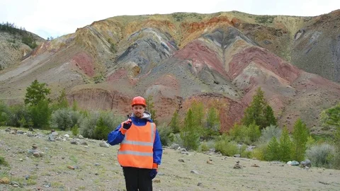 Mining engineer, a geologist in the protective reflective vest, gloves and Stock Footage 83492353