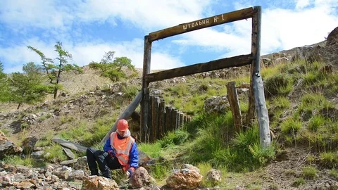 Mining engineer, a geologist in the protective reflective vest, gloves and Stock Footage 83499812