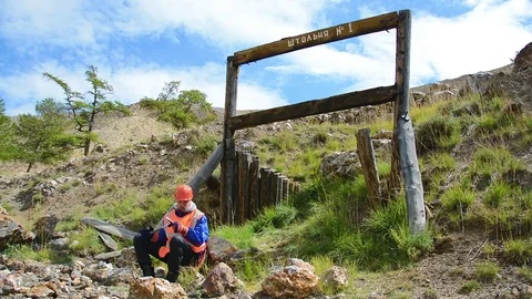 Mining engineer, a geologist in the protective reflective vest, gloves and Stock Footage 83501002