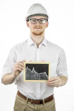 Mining engineer holding tablet with falling graph, looks at camera with smile Stock Photos