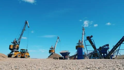 Mining equipment working. Working machines on a quarry, moving breakstones. Photos