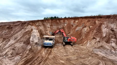 Mining Excavator Hitachi load sand in Belaz mining truck. Stock Footage 219721794