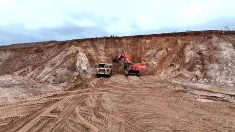 Mining Excavator Hitachi load sand in Belaz mining truckin in open-pit Видео 219732969