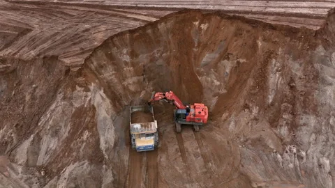 Mining Excavator Hitachi load sand in Belaz mining truckin in open-pit Stock-Footage 219733042