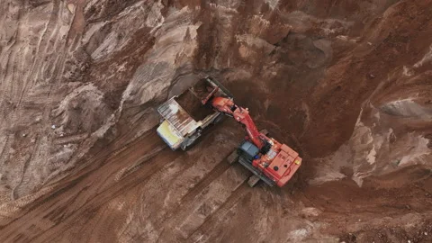 Mining Excavator Hitachi load sand in Belaz mining truckin in open-pit Stockbeeldmateriaal 219733739