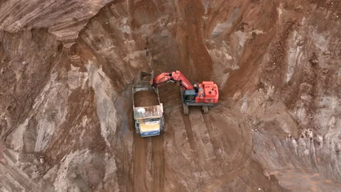 Mining Excavator Hitachi load sand in Belaz mining truckin in open-pit Stock Footage 219733801