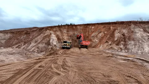Mining Excavator Hitachi load sand in Belaz mining truckin in open-pit Stock Footage 219733879