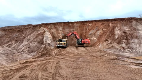 Mining Excavator Hitachi load sand in Belaz mining truckin in open-pit Stock Footage 219740128