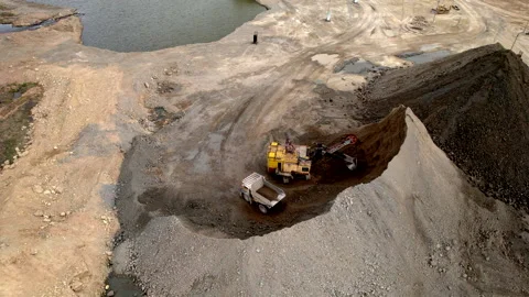 Mining excavator loading dolomite minerals in haul truck. Limestone mining Video stock 191155945