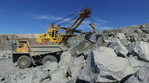 Mining. excavator loading granite or ore into dump truck Stock Footage 84118105