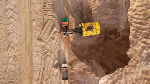 Mining excavator loads sand into dump truck. Sand mining in opencast. Stock Footage 195801090