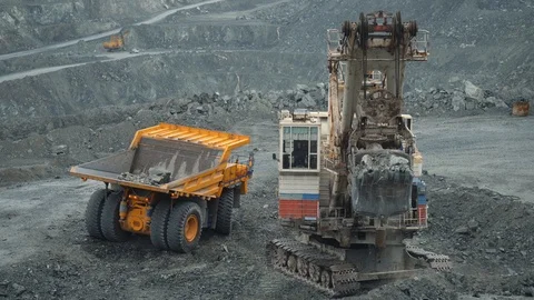 Mining excavator scooping up ore in a quarry. Close up of limestone mining. Stock Footage 99712577