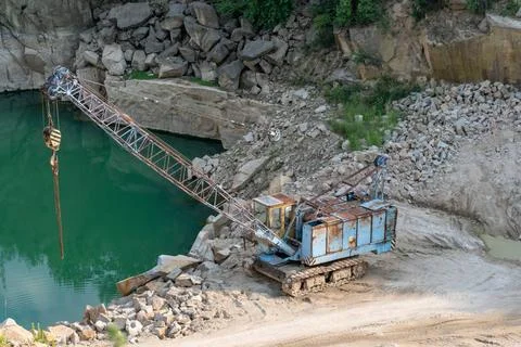  Mining in the granite quarry. Working mining machine - old crane. Mining ... Stock Photos