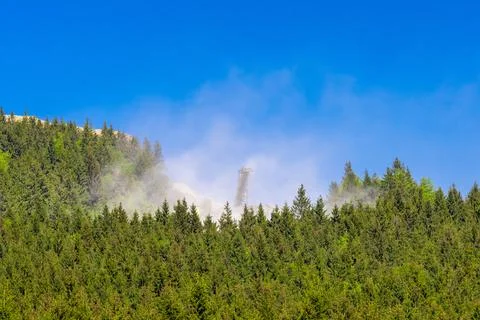 Mining in the heart of the mountain. The cloud of dust above the stone quarry Stock Photos