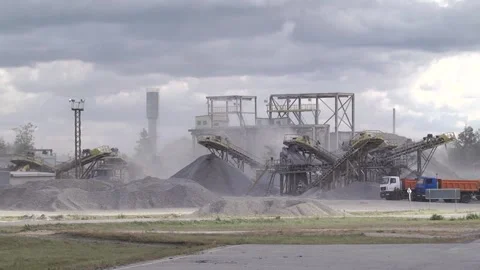 Mining industry.  Rock stone crushing machine against a blue sky Stock Footage 104713738