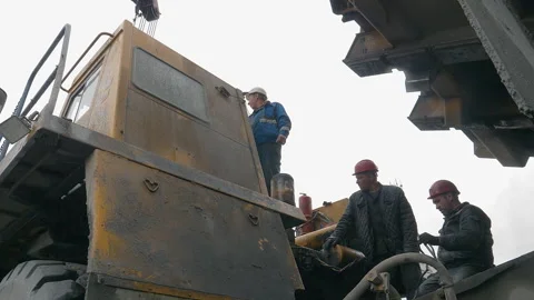 Mining industry workers in hard hats operating the complex equipment at a quarry Stock Footage 263272200