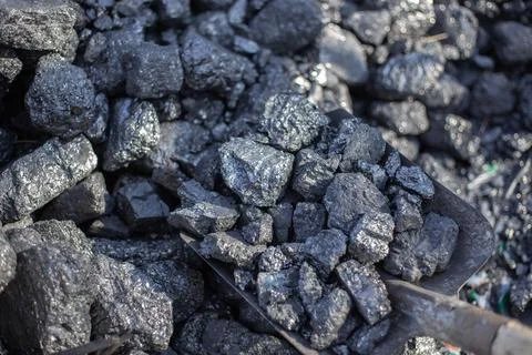 Mining. Large chunks of coal are shoveled with a shovel, mineral fuel for hom Stock Photos