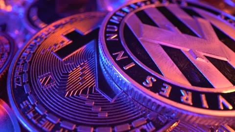 Mining. Litecoin, Etherium, Bitcoin rotate on the surface with blue neon and Stock Footage 134524995