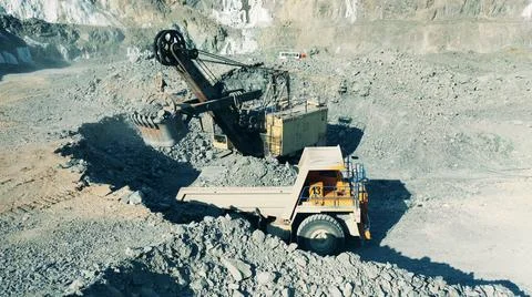 Mining machines are extracting copper ore in the quarry Photos