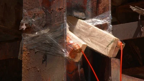 Mining of a metal structure with a red dynamite block TNT. Blasting Specialists. Stock Footage 129399985