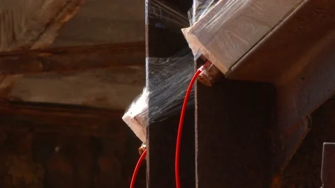 Mining of a metal structure with a red dynamite block TNT. Blasting Specialists. Stock Footage 131552108